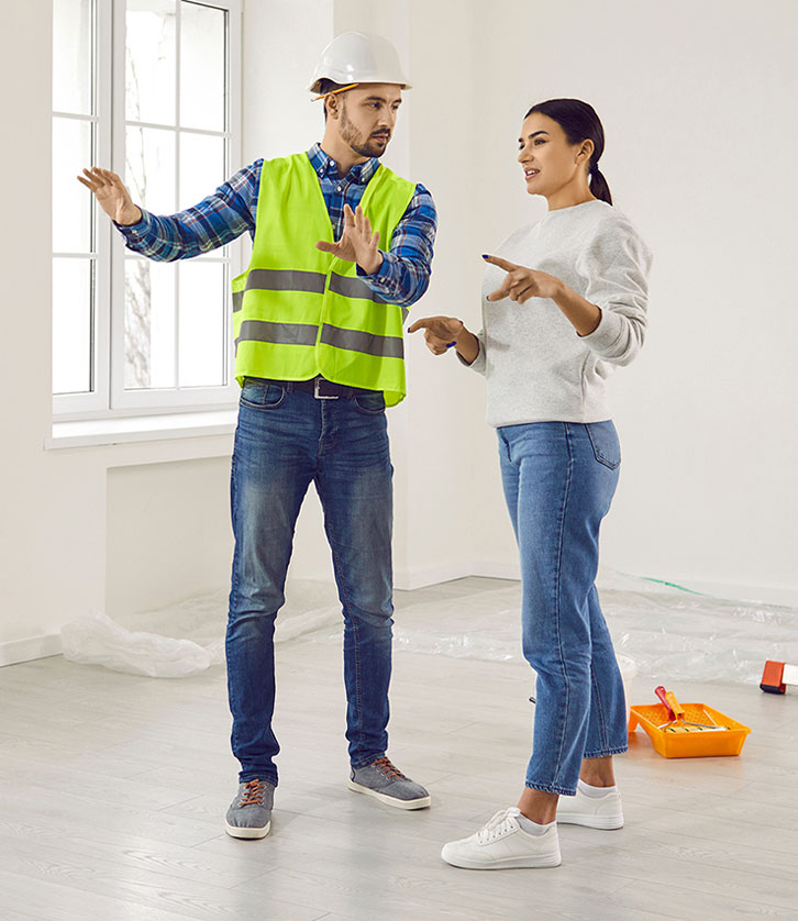 Contractor consulting with a homeowner in a partially finished build. 